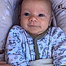 Aaron participe au concours pour gagner de l'argent avec cette photo : baby, infant, child, onesie, blue_eyes, smile, hand, blanket, cushion, patterned_clothing, cozy, soft_texture, star_pattern, indoor, portrait, cute, resting, human, closeup, comfort