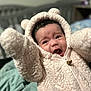 baby, child, hoodie, fluffy, cute, indoor, portrait, expression, arms_up, clothing, infant, face, person, warm, bedroom, blanket, soft, young, fur, zipper