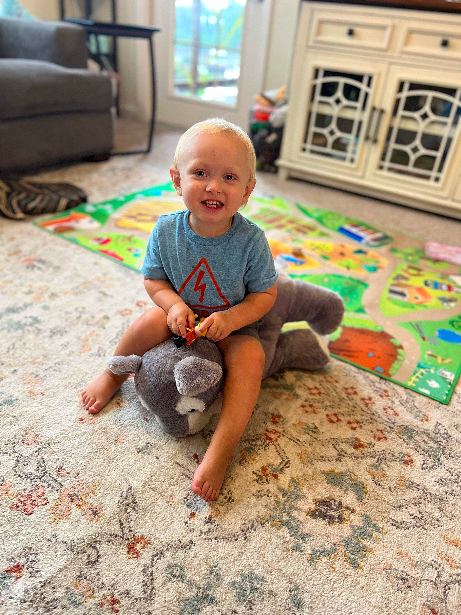 Oliver joined the competition — help win amazing prizes! baby, baby_toddler_clothing, barefoot, carpet, child, comfort, floor, flooring, foot, fun, happy, hardwood, joy, living_room, person, play, room, sitting, smile, t_shirt