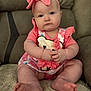 baby, child, infant, pink_clothing, headband, bow, sitting, soft_surface, cute, portrait, indoor, plush, feet, hands, face, blue_eyes, furniture, couch, closeup, expression