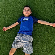 Solomon joined the competition — help win amazing prizes! child, boy, smile, grass, outdoor, nike_shirt, shorts, casual_clothing, playing, fun, leisure, summer, relaxation, happy, young, person, nature, greenery, posing, recreation