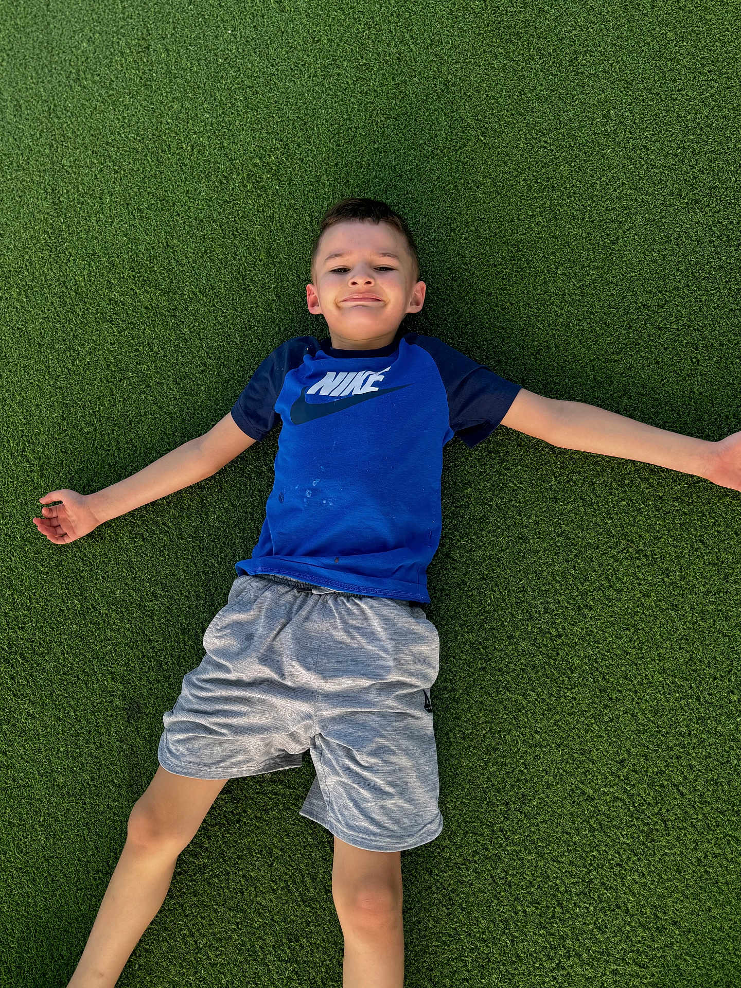 Solomon joined the competition — help win amazing prizes! child, boy, smile, grass, outdoor, nike_shirt, shorts, casual_clothing, playing, fun, leisure, summer, relaxation, happy, young, person, nature, greenery, posing, recreation
