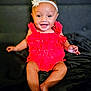 Naomi joined the competition — help win amazing prizes! baby, infant, smiling, red_clothing, headband, flower, sitting, barefoot, cute, portrait, happy, child, indoors, face, person, young_child, skin, expression, one_person, closeup