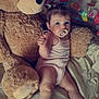 baby, pacifier, teddy_bear, plush_toy, bed, blanket, pajamas, child, cute, indoor, soft_toy, infant, face, hair_ties, lying_down, comfort, cozy, toy, sleepwear, relax
