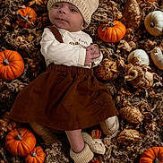Winter joined the competition — help win amazing prizes! baby, infant, knit_hat, brown_dress, pumpkins, autumn, gourds, fall, cozy, cute, baby_booties, lying_down, seasonal, decor, warm_clothing, outdoor_style, harvest, small_face, child, adorable