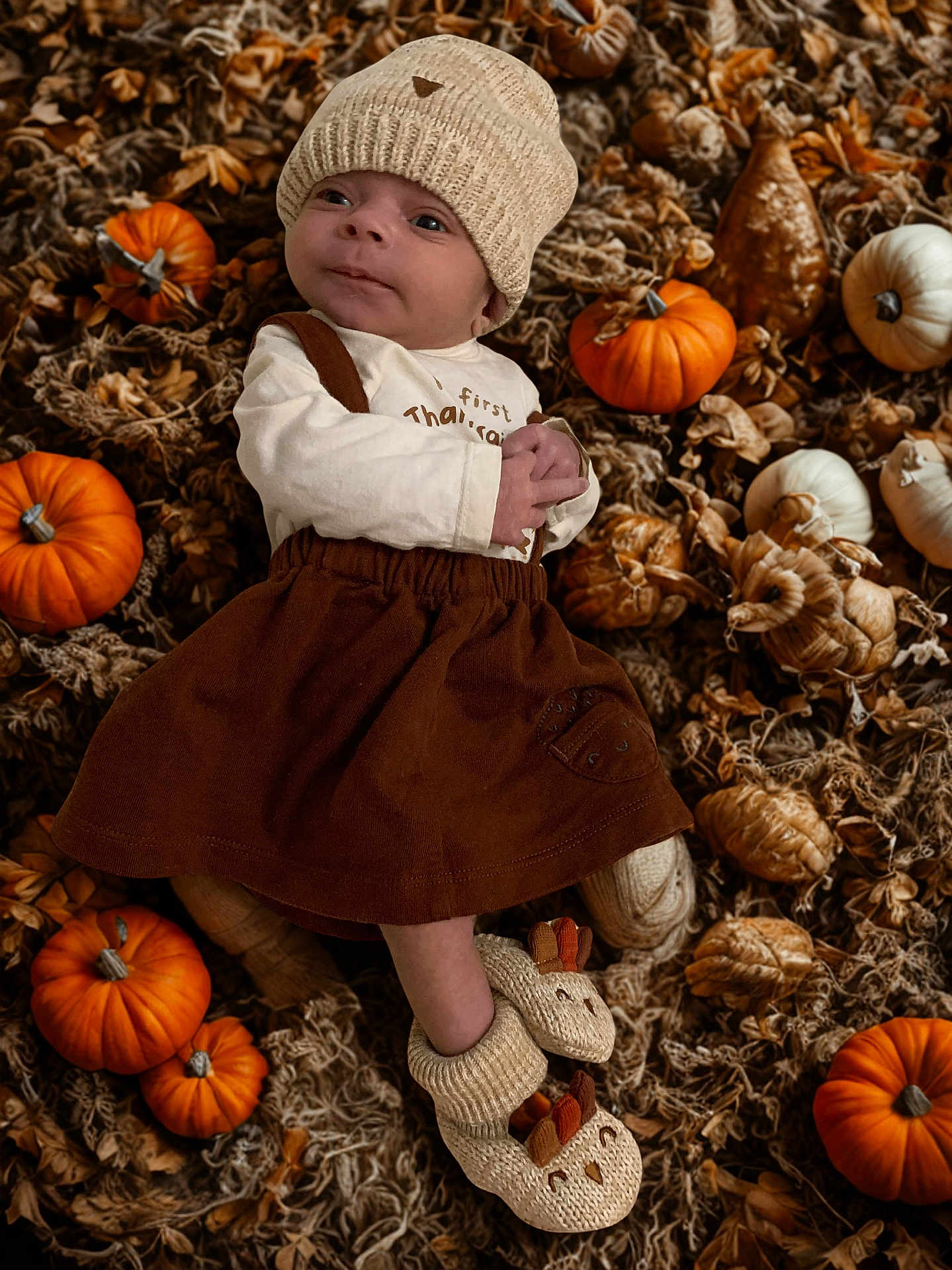 Winter joined the competition — help win amazing prizes! baby, infant, knit_hat, brown_dress, pumpkins, autumn, gourds, fall, cozy, cute, baby_booties, lying_down, seasonal, decor, warm_clothing, outdoor_style, harvest, small_face, child, adorable