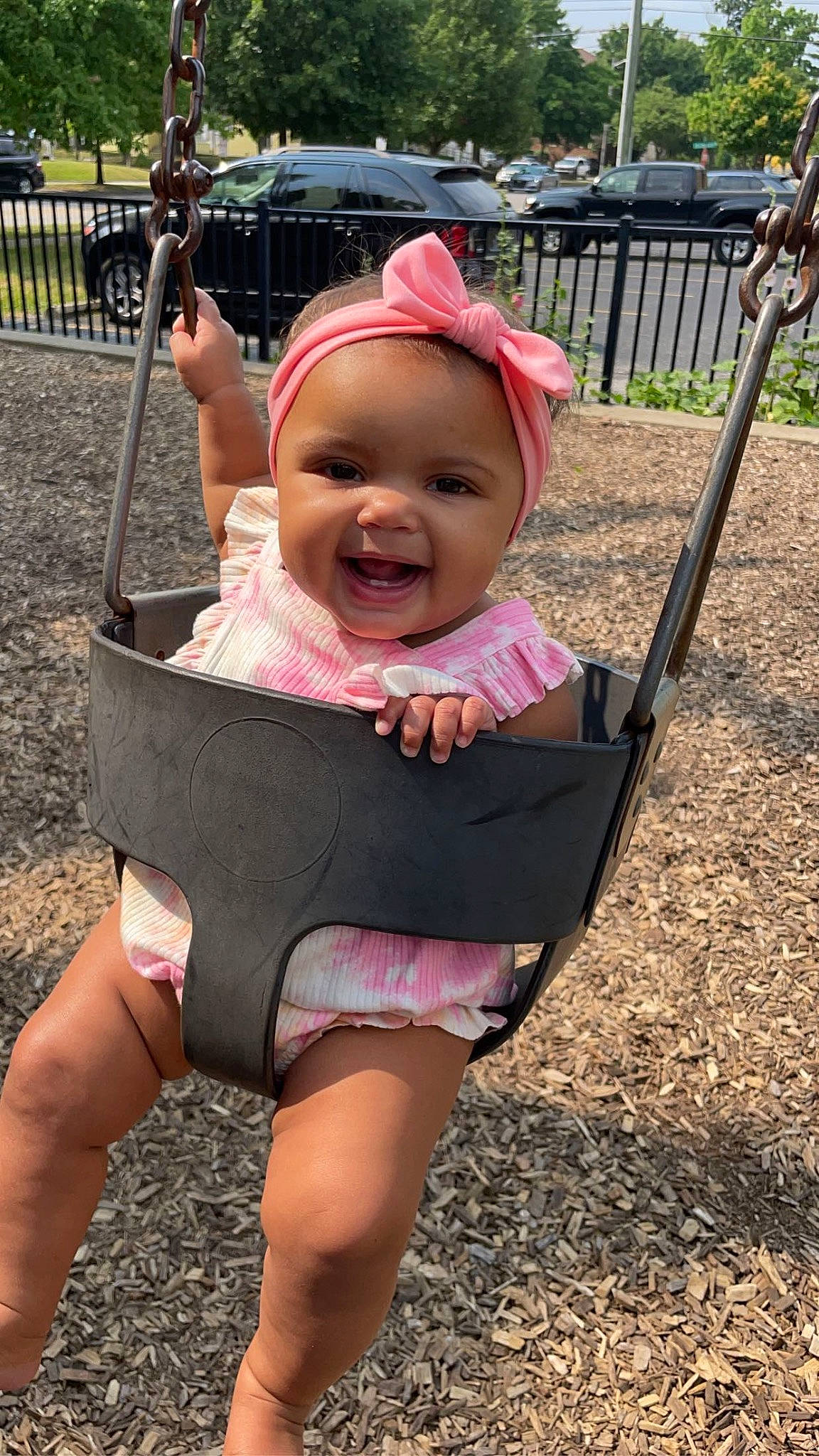 Maleah joined the competition — help win amazing prizes! baby, baby_products, baby_toddler_clothing, city, fun, grass, happy, hat, joy, leisure, person, pink, plant, recreation, sitting, smile, sun_hat, swing, thigh, toddler