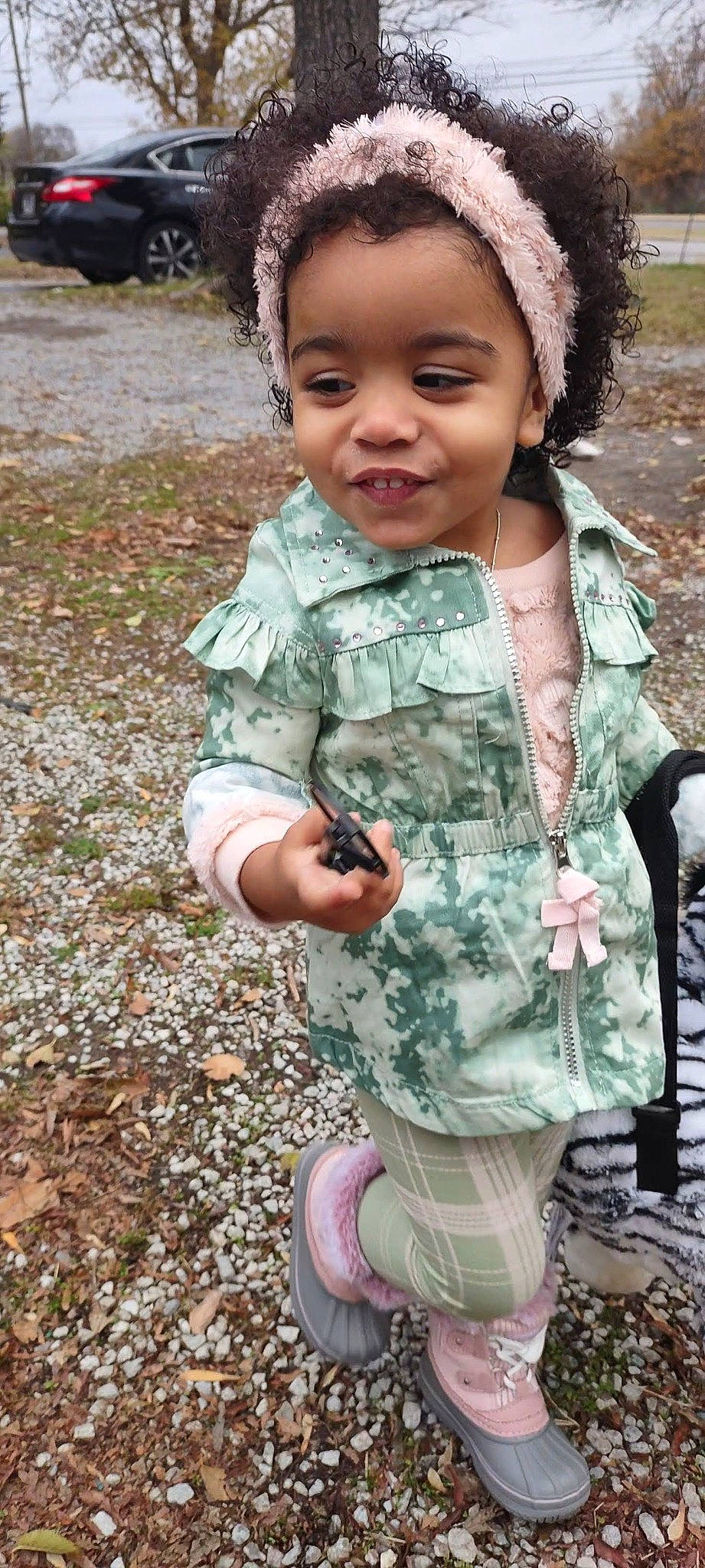 Rebecca is registered to the contest to win money with this photo: baby_toddler_clothing, child, eyelash, face, fashion_accessory, gesture, grass, hairstyle, happy, head, headband, joy, military_camouflage, pattern, people_in_nature, person, pink, plant, skin, sleeve