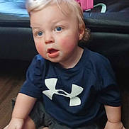 Kai joined the competition — help win amazing prizes! toddler, child, blue_eyes, rosy_cheeks, navy_shirt, sneakers, pink_backpack, wooden_floor, couch, indoor, sitting, curious, casual, shorts, person, young_child, small_hands, hair, face, clothing