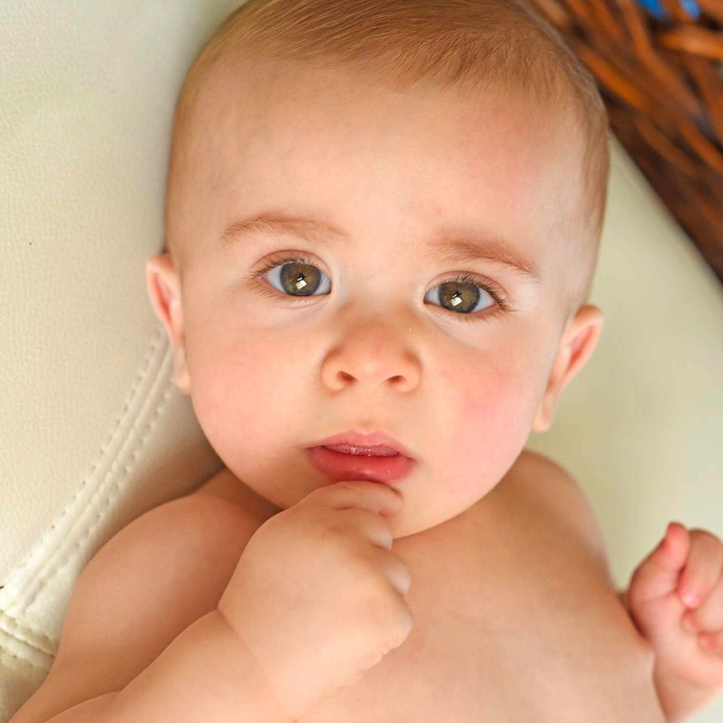 Nicholas is registered to the contest to win money with this photo: baby, biting, blonde, bodypart, face, finger, frown, furniture, hair, hand, happy, head, neck, newborn, person, photography, portrait, sad, skin, smile