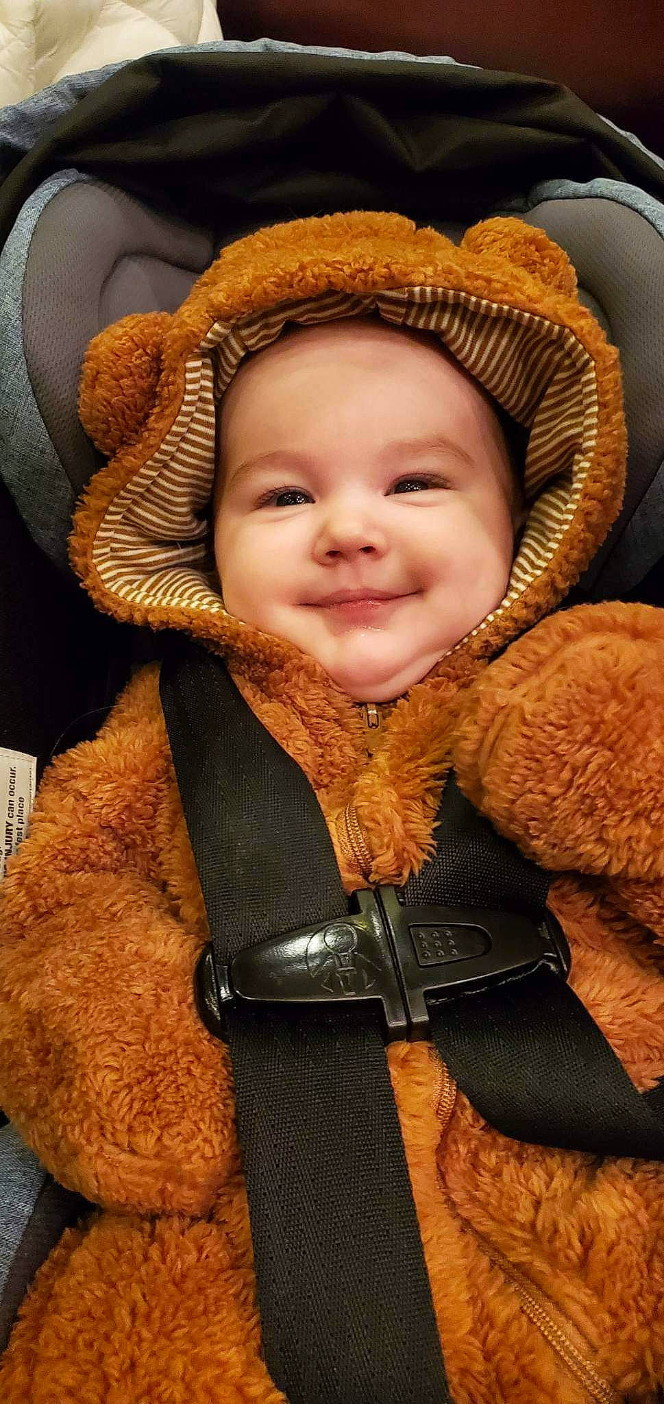 Travis is registered to the contest to win money with this photo: baby, baby_toddler_clothing, cheek, child, comfort, eye, face, happy, hat, head, iris, jacket, joy, nose, organ, outerwear, person, skin, sleeve, smile