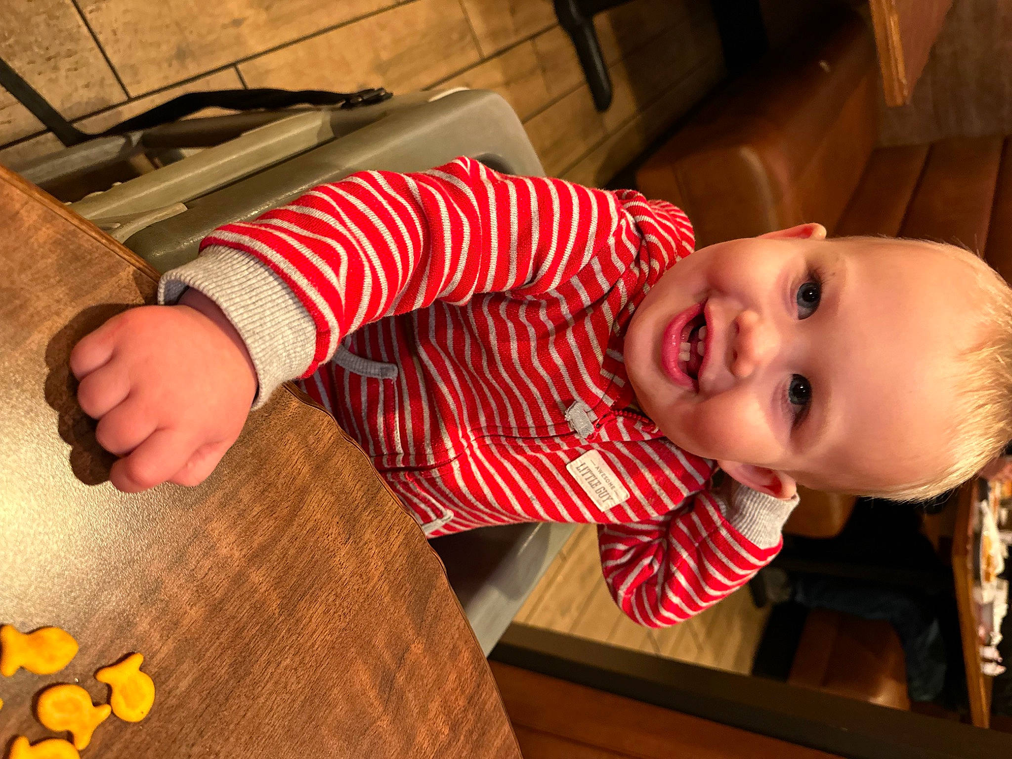 Landon is registered to the contest to win money with this photo: baby, baby_toddler_clothing, child, dress, finger, floor, flooring, fun, happy, joy, nose, orange, pattern, person, product, skin, sleeve, smile, standing, t_shirt