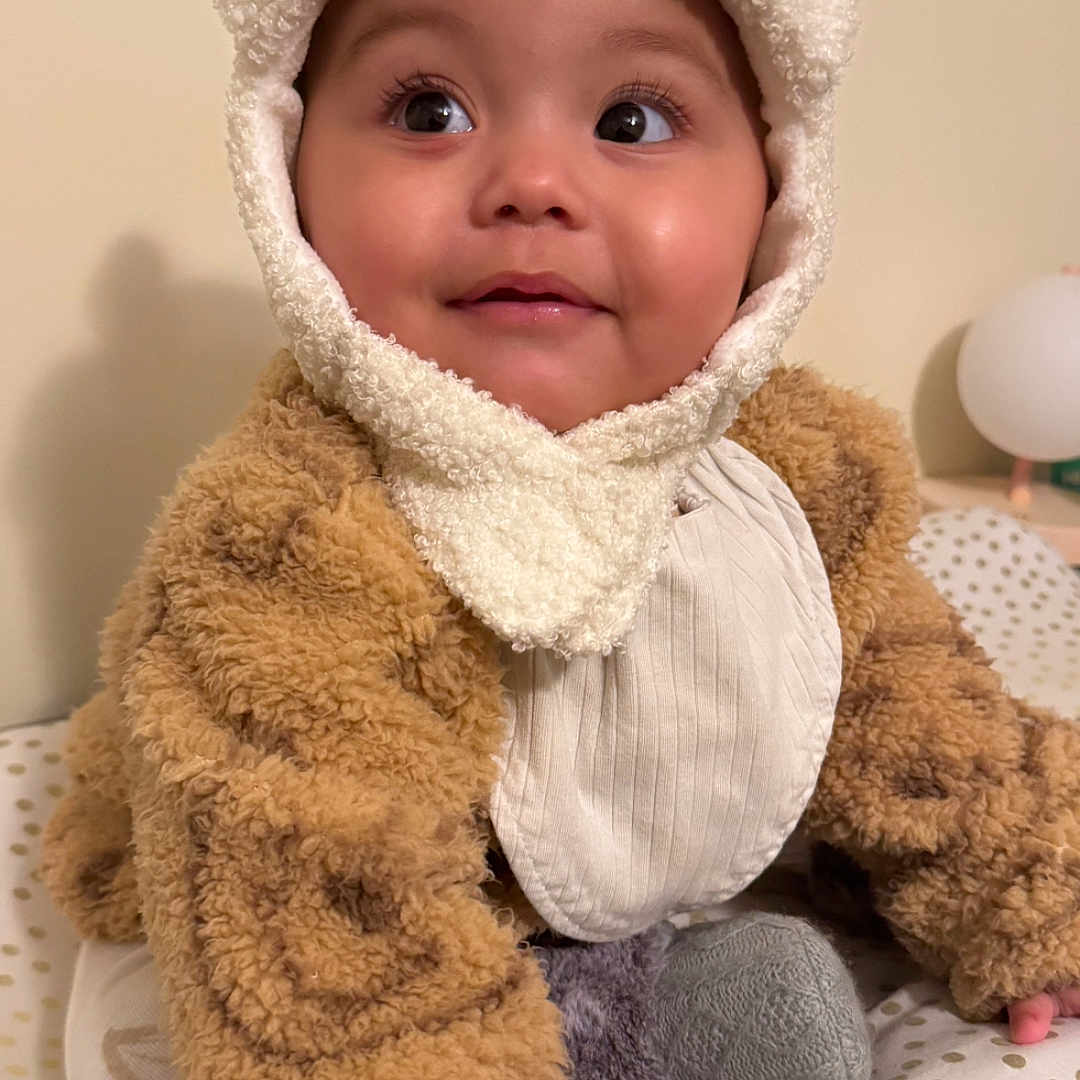 Maya Shelton joined the competition — help win amazing prizes! beanie, bodypart, bonnet, cap, clothing, doll, face, finger, hand, hat, head, hood, hoodie, knitwear, person, photography, portrait, sweater, sweatshirt, toy