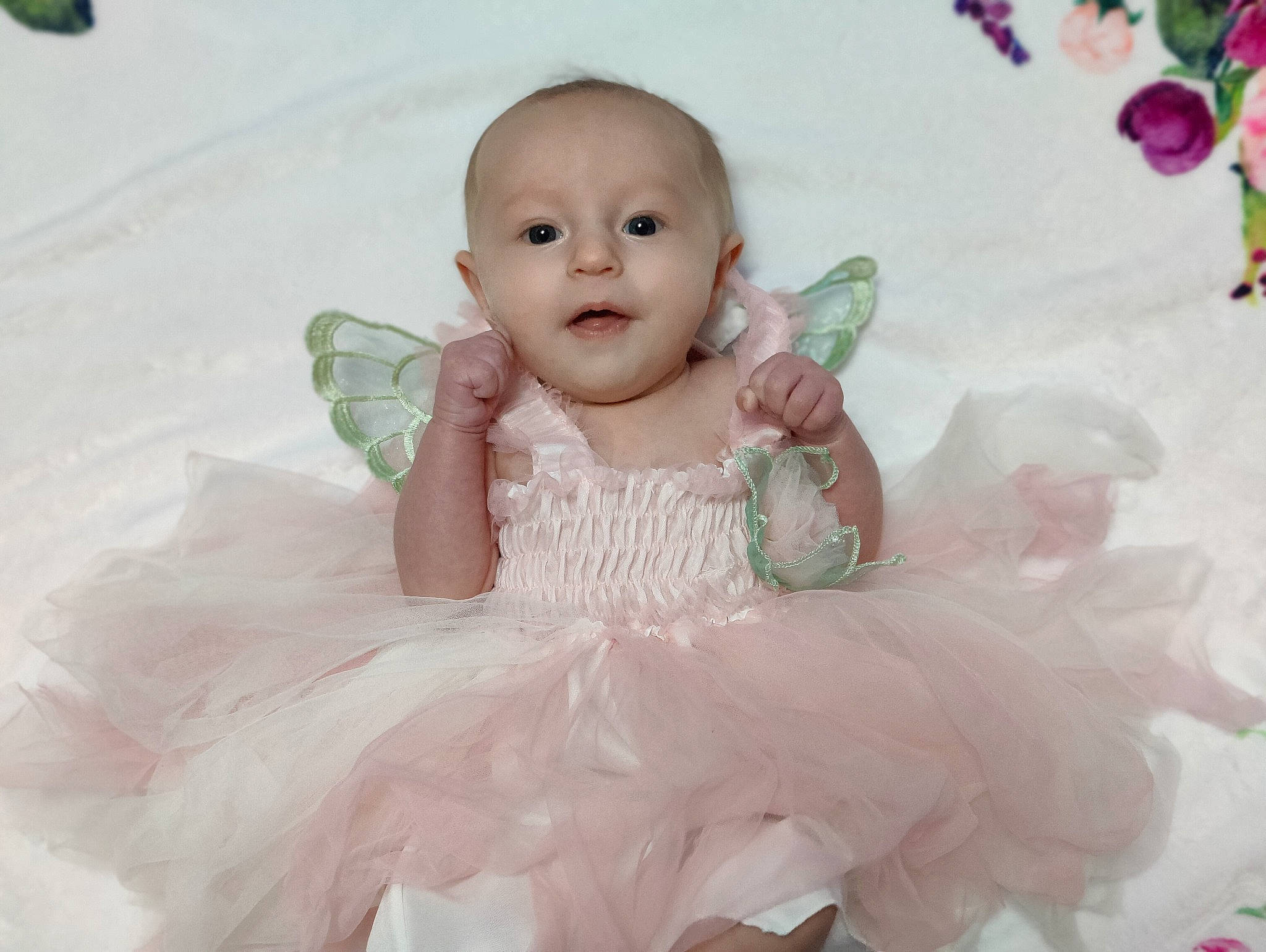 Rayla is registered to the contest to win money with this photo: baby, baby_toddler_clothing, beauty, child, dress, embellishment, event, face, happy, headpiece, iris, person, pink, product, ruffle, skin, sleeve, smile, textile, toddler