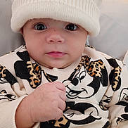 Aaliyah is registered to the contest to win money with this photo: baby, child, hat, knit_hat, pom_poms, mickey_mouse, sweater, leopard_print, cute, close_up, face, fist, apparel, infant, portrait, indoor, warm_clothing, expression, young_child, adorable