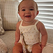 Paisley joined the competition — help win amazing prizes! baby, smiling, pacifier, couch, pillows, window_blinds, indoor, child, happy, toes, clothing, sitting, face, infant, home, blanket, cute, relaxed, soft_lighting, domestic