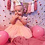 baby, infant, birthday, party_hat, pink_dress, balloons, tulle, celebration, tassels, decorations, cute, smiling, sitting, indoors, face, child, festive, young_child, adorable, background