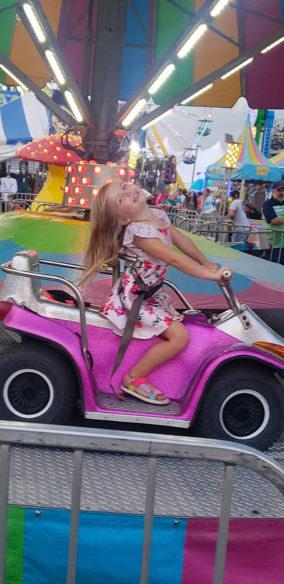 Callie is registered to the contest to win money with this photo: automotive_design, automotive_tire, automotive_wheel_system, bumper, car, fender, fun, joy, leisure, magenta, mode_of_transport, motor_vehicle, person, pink, product, purple, recreation, riding_toy, shorts, tire