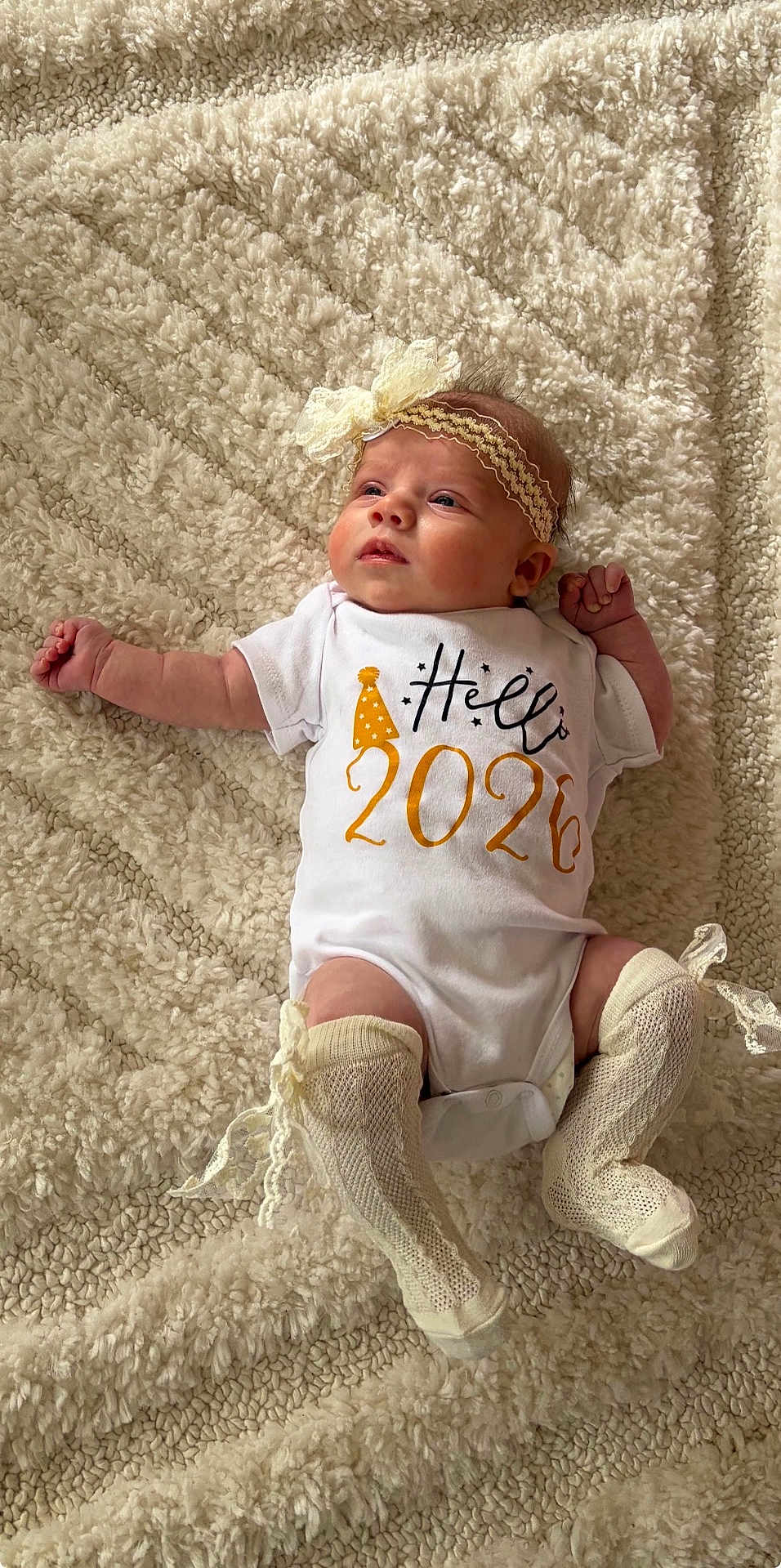 Nirvana joined the competition — help win amazing prizes! baby, infant, onesie, headband, bow, socks, lace, blanket, fluffy, cute, new_year, party_hat, clothing, lying_down, indoors, portrait, child, soft_texture, curious, celebration