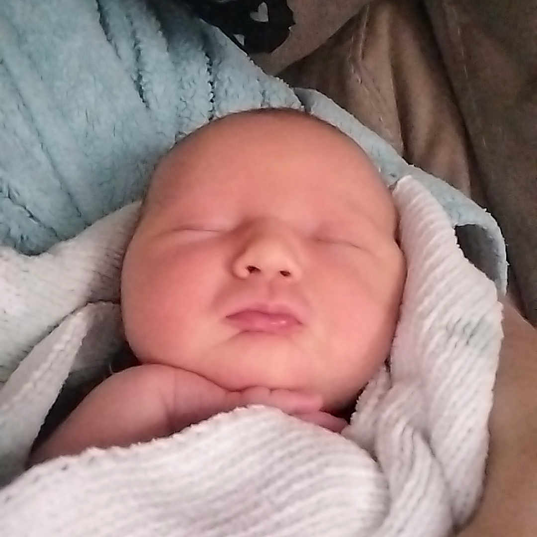 Harry joined the competition — help win amazing prizes! baby, blanket, child, comfort, couch, cozy, face, hand, indoors, infant, newborn, peace, peaceful, portrait, resting, sleeping, soft, toddler, warmth, wrapped