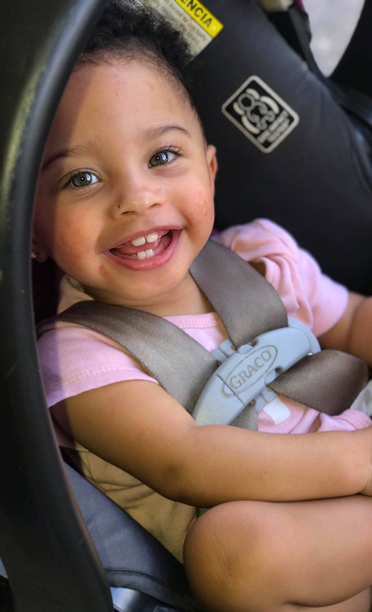 Abby is registered to the contest to win money with this photo: auto_part, baby, baby_carriage, baby_in_car_seat, car_seat, cheek, child, joy, person, seat_belt, sitting, skin, smile, toddler