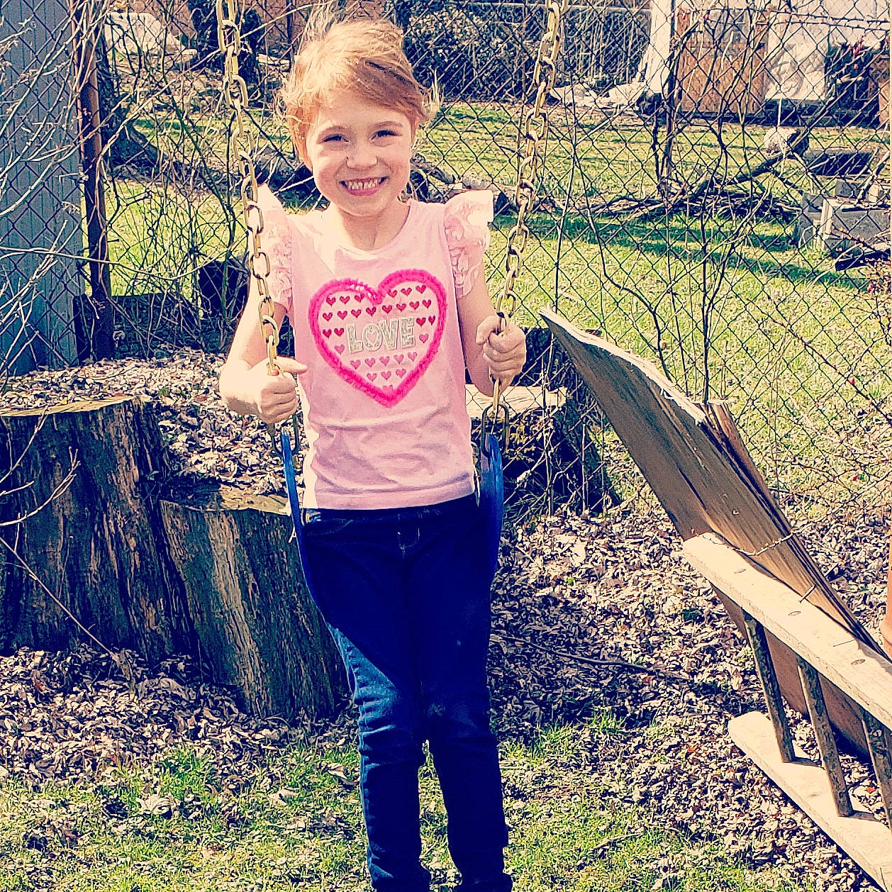 Joella is registered to the contest to win money with this photo: blond, child, cool, denim, face, facial_expression, footwear, grass, happy, jeans, joy, leaf, person, photography, pink, plant, play, smile, spring, t_shirt
