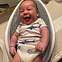 baby, infant, smiling, onesie, shark_pattern, fish_pattern, baby_bath_seat, bathroom, tile_floor, happy, cute, child, skin, hand, leg, sitting, indoor, plump, chubby, joyful