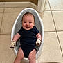 Weston joined the competition — help win amazing prizes! baby, smiling, onesie, mittens, infant_bath_seat, floor, tile_floor, indoor, child, happy, person, seated, skin, head, arm, leg, door_frame, wall, home, cute