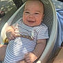 baby, smiling, striped_onesie, baby_seat, beaded_toy, happy, infant, outdoor, sunlight, shadow, skin, person, cute, chubby, relaxed, seat, plastic, hand, foot, daylight