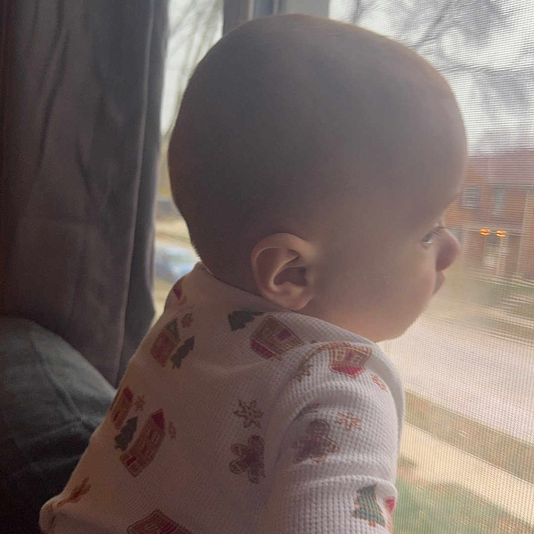 Lucas is registered to the contest to win money with this photo: baby, bodypart, clothing, couch, crawling, cushion, dress, face, finger, furniture, hand, head, homedecor, pants, person, photography, portrait, sitting, undershirt, window