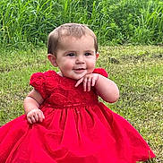 Jazmine joined the competition — help win amazing prizes! baby, child, red_dress, grass, outdoor, smiling, cute, nature, greenery, sitting, portrait, happy, young_child, infant, person, baby_girl, summer, playful, barefoot, innocent