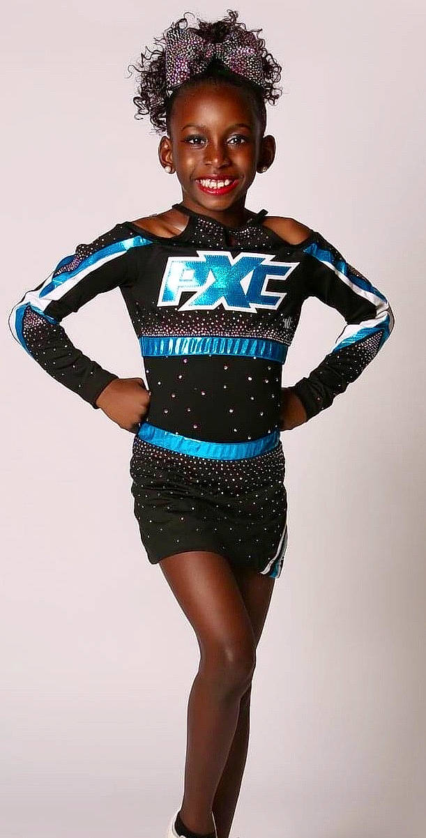 Jamiya is registered to the contest to win money with this photo: cheerleading_uniform, clothing, electric_blue, joy, majorette_dancer, performance, person, photo_shoot, sleeve, sports_uniform, sportswear, uniform