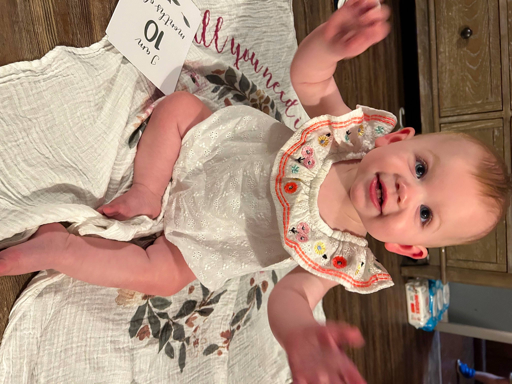 Raelyn is registered to the contest to win money with this photo: arm, baby, baby_products, baby_toddler_clothing, cheek, child, comfort, fun, hand, happy, human_body, joy, pattern, person, pink, sitting, skin, smile, textile, thigh
