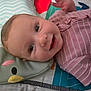 Peyton joined the competition — help win amazing prizes! baby, smiling, infant, face, pink_clothing, striped, lying_down, playmat, pillow, animal_pillow, cute, happy, child, indoors, closeup, young_child, hand, skin, head, eyes