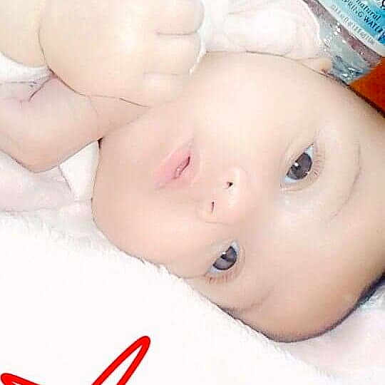 Attarah is registered to the contest to win money with this photo: cheek, child, chin, close_up, ear, face, finger, forehead, girl, hand, head, infant, lip, mouth, nose, product, skin