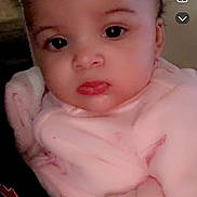 Jyra joined the competition — help win amazing prizes! baby, infant, face, portrait, pink_blanket, soft_clothing, curly_hair, indoor, closeup, child, cute, young, person, skin, eyes, expression, head, holding, warm, newborn