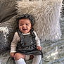 Jyra is registered to the contest to win money with this photo: baby, infant, smiling, happy, child, bed, pillow, fluffy_pillow, blanket, clothing, hat, white_socks, sitting, indoors, cute, portrait, soft_lighting, cozy, fashion, young_child