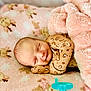 baby, sleeping, blanket, pacifier, cozy, infant, cute, soft, animal_print, pink, leopard_print, newborn, peaceful, child, resting, clothing, indoors, portrait, comfort, toddler