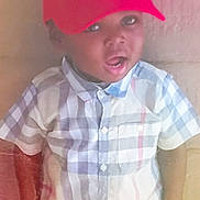 Jordan is registered to the contest to win money with this photo: background, buttoned_shirt, casual_clothing, checkered_shirt, child, cute, expression, eyes, face, headwear, indoor, light, mouth_open, person, portrait, red_cap, short_sleeve, sitting, skin_tone, young_child