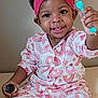 Saniyah Heaven is registered to the contest to win money with this photo: toddler, child, smiling, headband, pink, bow, pajamas, rainbow_pattern, sitting, holding, bottle, blue_object, indoor, portrait, cute, happy, person, baby, face, clothing