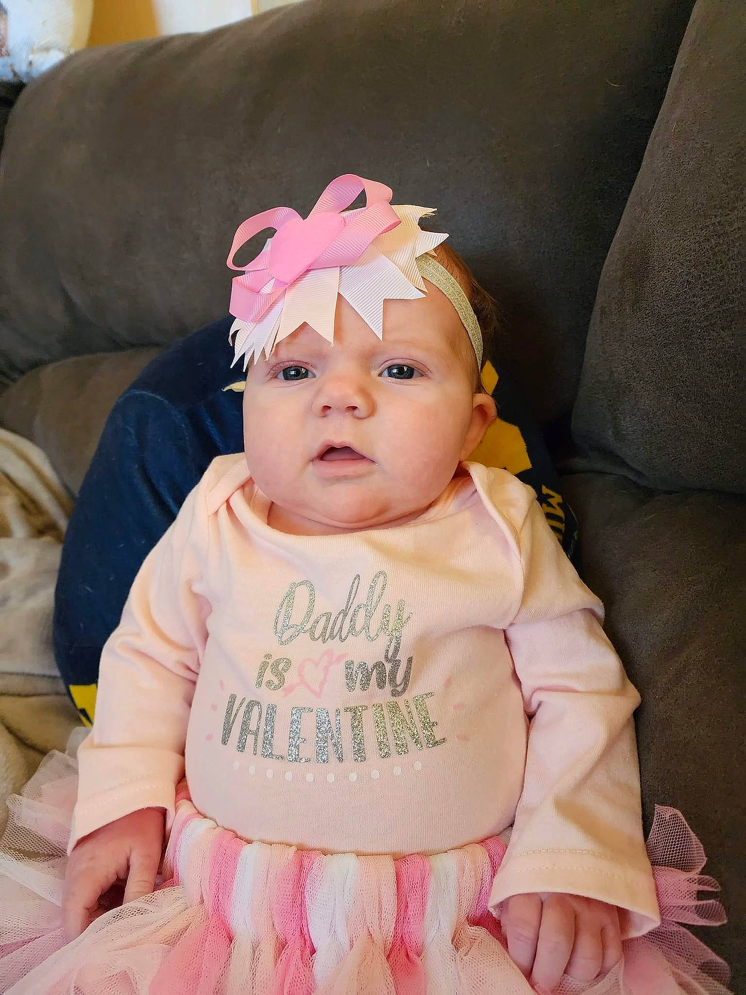 Freya is registered to the contest to win money with this photo: baby, baby_products, baby_toddler_clothing, cheek, child, comfort, couch, eyelash, fashion_accessory, happy, headband, headwear, iris, magenta, person, pink, purple, sitting, skin, sleeve