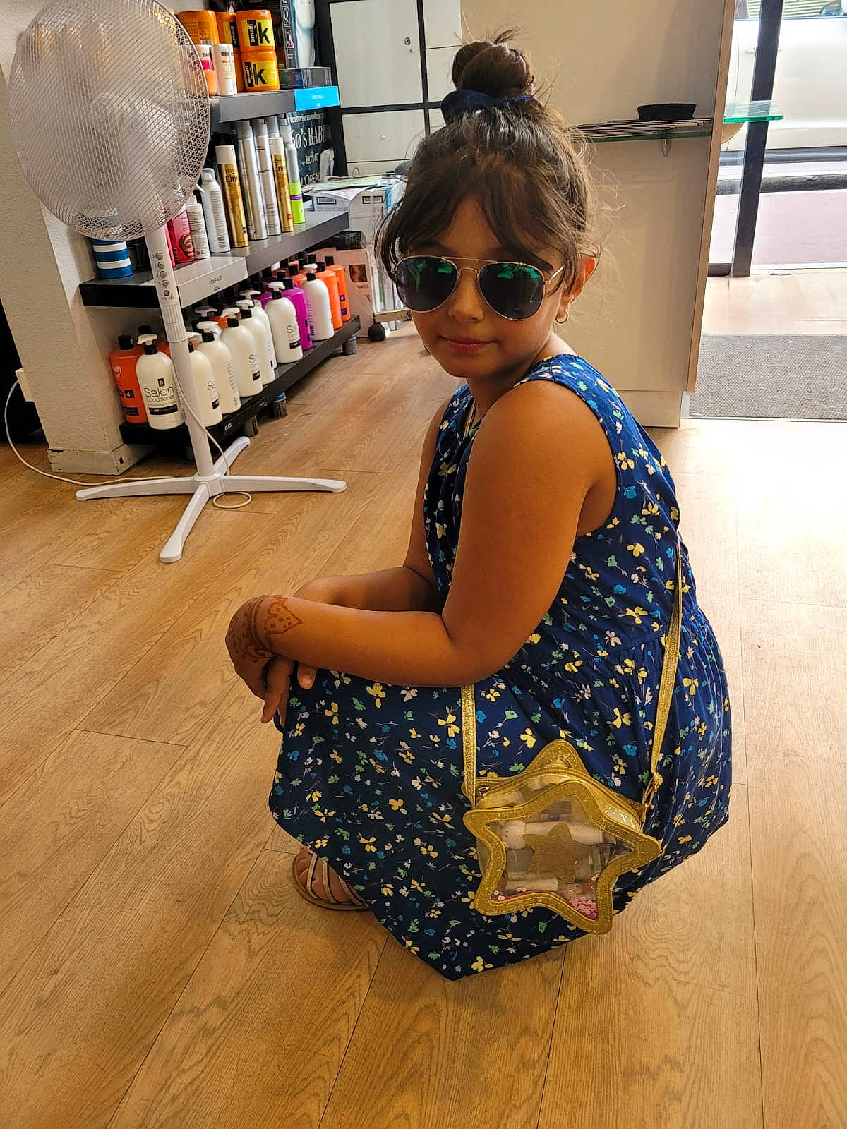 Léna a rejoint le concours — aidez-le/la à gagner de superbes lots ! bookcase, electric_blue, eyewear, fashion_design, floor, flooring, glasses, goggles, hairstyle, hardwood, human_leg, person, shelf, shelving, shoulder, smile, sunglasses, thigh, vision_care, waist