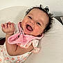 Zeina-Pierina joined the competition — help win amazing prizes! baby, smiling, laughing, curly_hair, pink_bib, floral_clothing, infant, cute, happy, indoors, cushion, white_background, person, child, portrait, closeup, skin, hand, face, lying_down