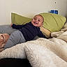Jahmari joined the competition — help win amazing prizes! baby, child, smiling, happy, portrait, indoors, bed, blanket, pillows, couch, clothing, striped_pants, long_sleeves, sitting, lying_down, home, bedroom, furniture, cozy, photography