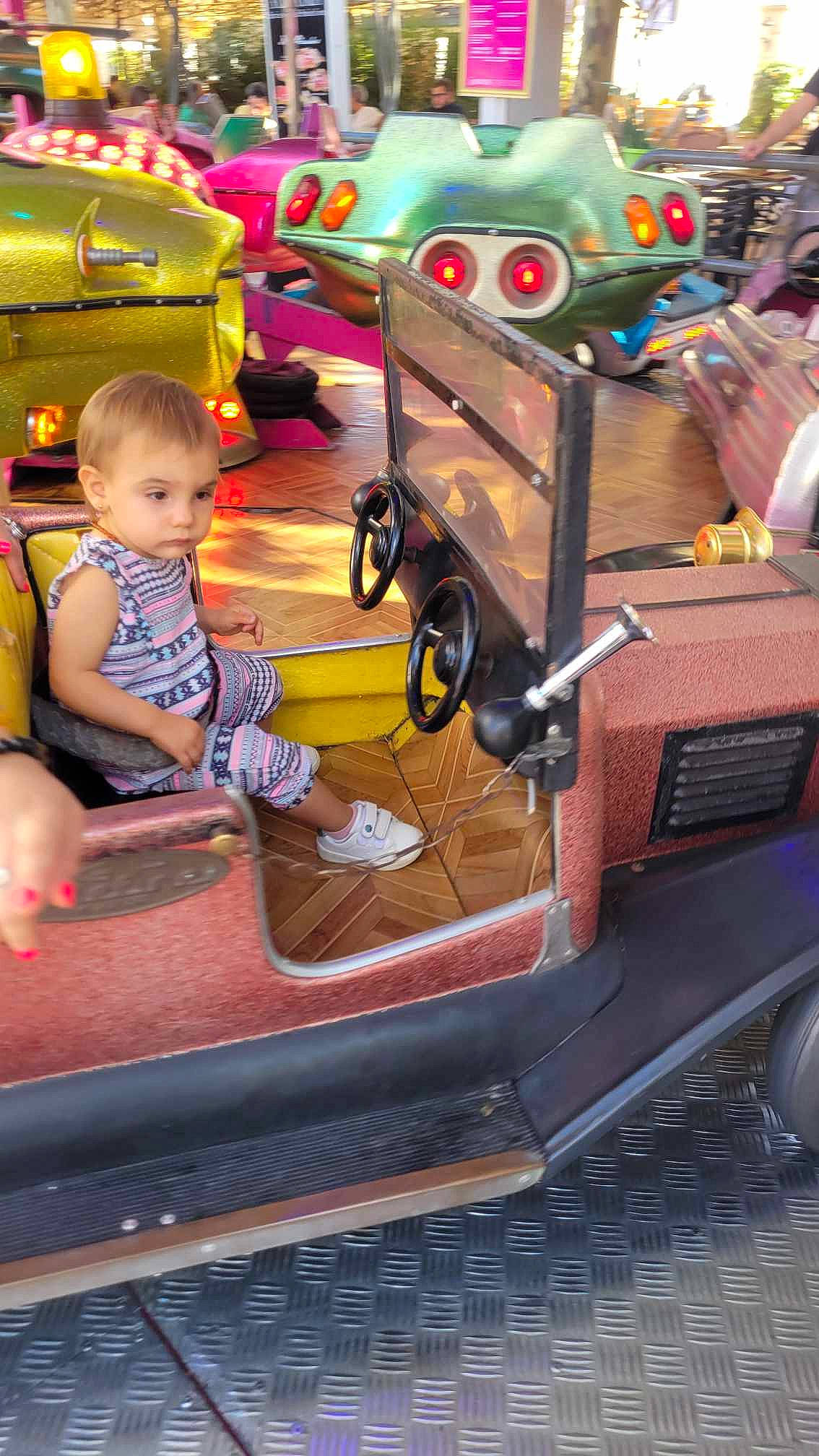 Lesia participe au concours pour gagner de l'argent avec cette photo : amusement_ride, automotive_design, automotive_exterior, automotive_tire, baby, baby_toddler_clothing, bumper, child, city, fun, leisure, machine, mode_of_transport, motor_vehicle, person, play, playground, public_space, recreation, toddler