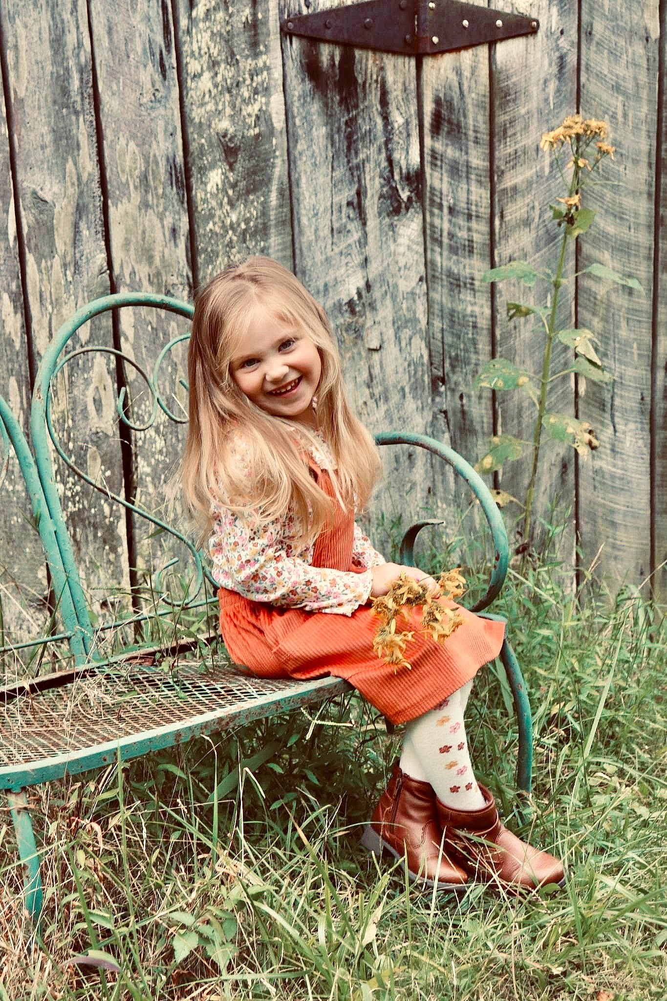 Payton is registered to the contest to win money with this photo: blond, boot, brown_hair, child, dress, fawn, forest, grass, happy, human_leg, joy, leisure, long_hair, people_in_nature, person, plant, shoe, smile, thigh, trunk