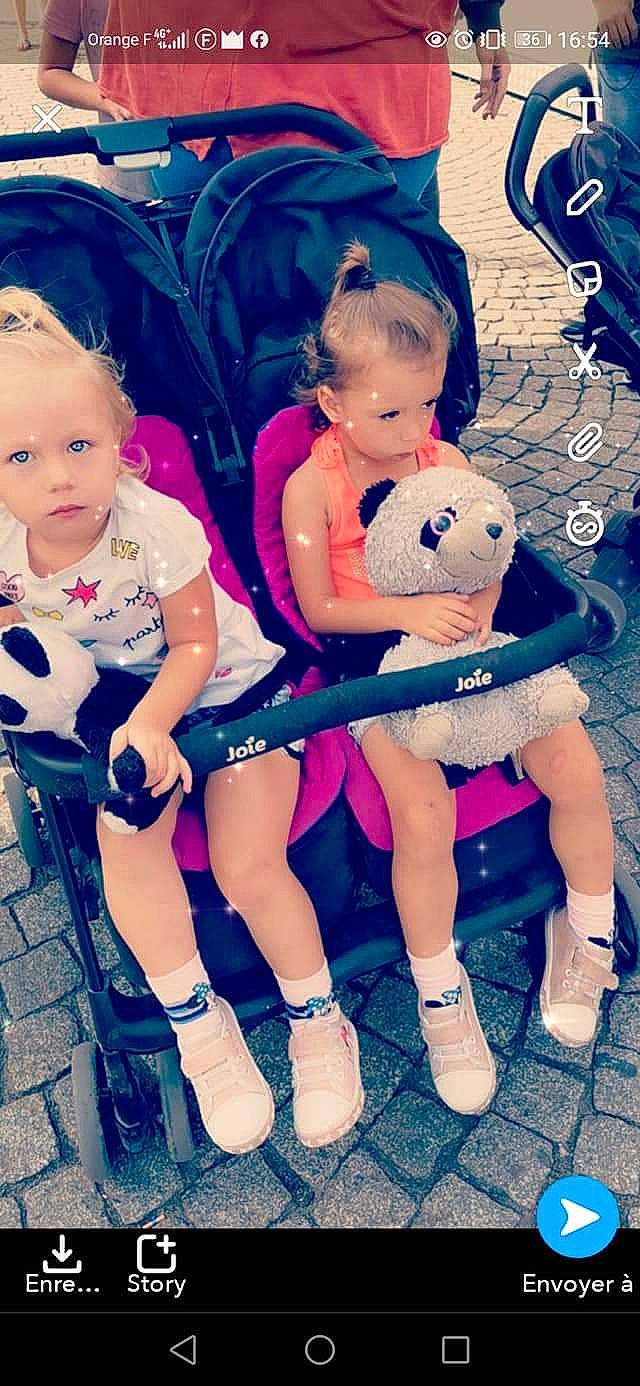 Lyna participe au concours pour gagner de l'argent avec cette photo : baby, baby_products, child, child_model, doll, footwear, hair_accessory, happy, headgear, leg, person, photography, pink, play, product, shoe, sibling, sitting, smile, toddler