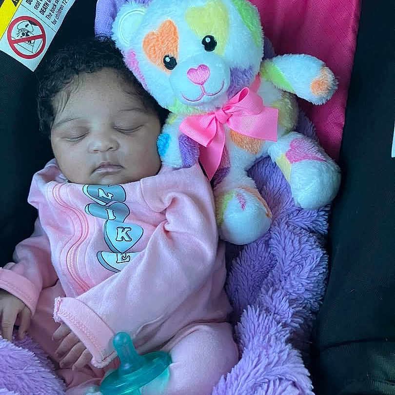 Emonee is registered to the contest to win money with this photo: baby, bed, blanket, crib, cushion, doll, face, furniture, head, homedecor, infantbed, newborn, person, photography, portrait, sleeping, teddybear, toy, yawning