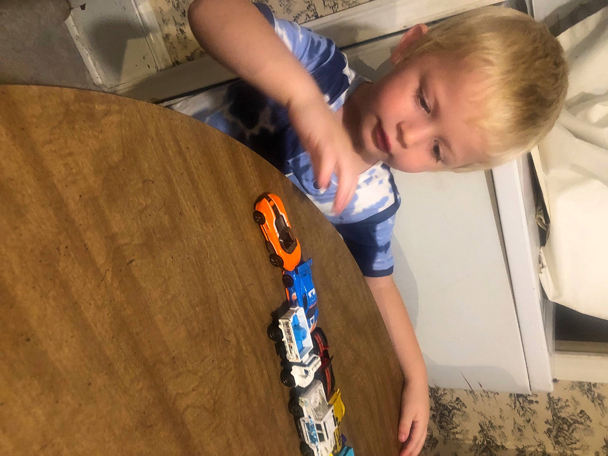 Ryland joined the competition — help win amazing prizes! automotive_design, automotive_wheel_system, chair, child, floor, flooring, fun, hardwood, leisure, person, plywood, recreation, room, sitting, t_shirt, toddler, varnish, vehicle_door, wheel, wood