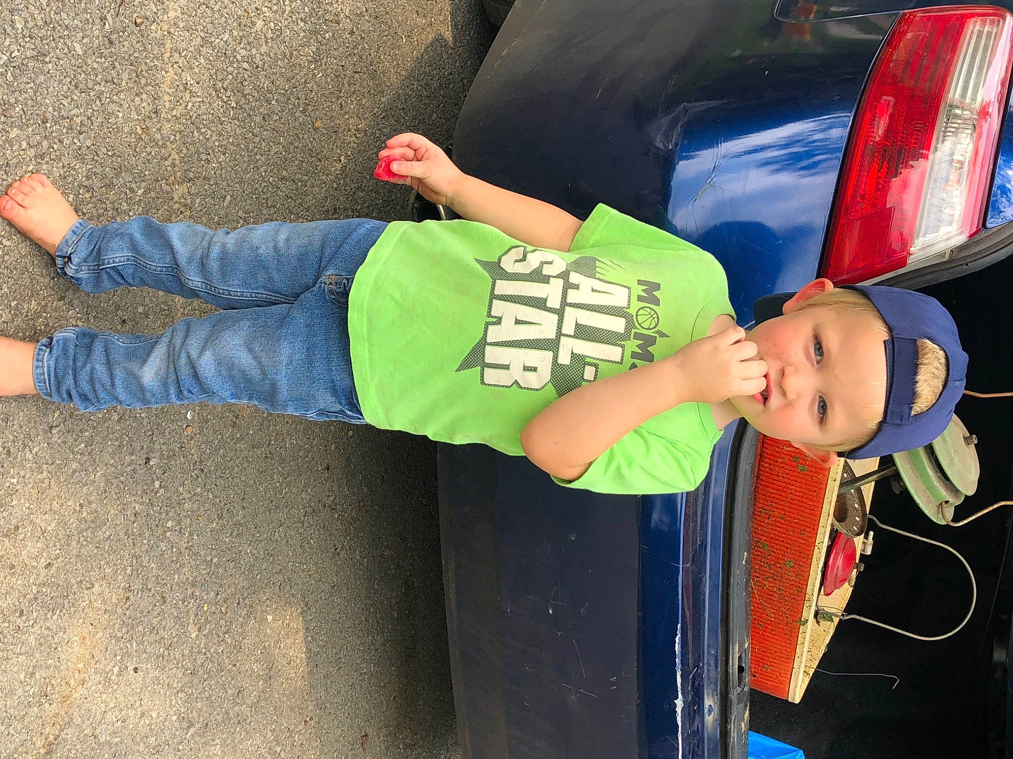 Ryland is registered to the contest to win money with this photo: auto_part, automotive_design, automotive_exterior, automotive_lighting, bumper, child, denim, electric_blue, fun, hat, headwear, human_leg, leisure, motor_vehicle, person, recreation, street_fashion, t_shirt, toddler, trunk